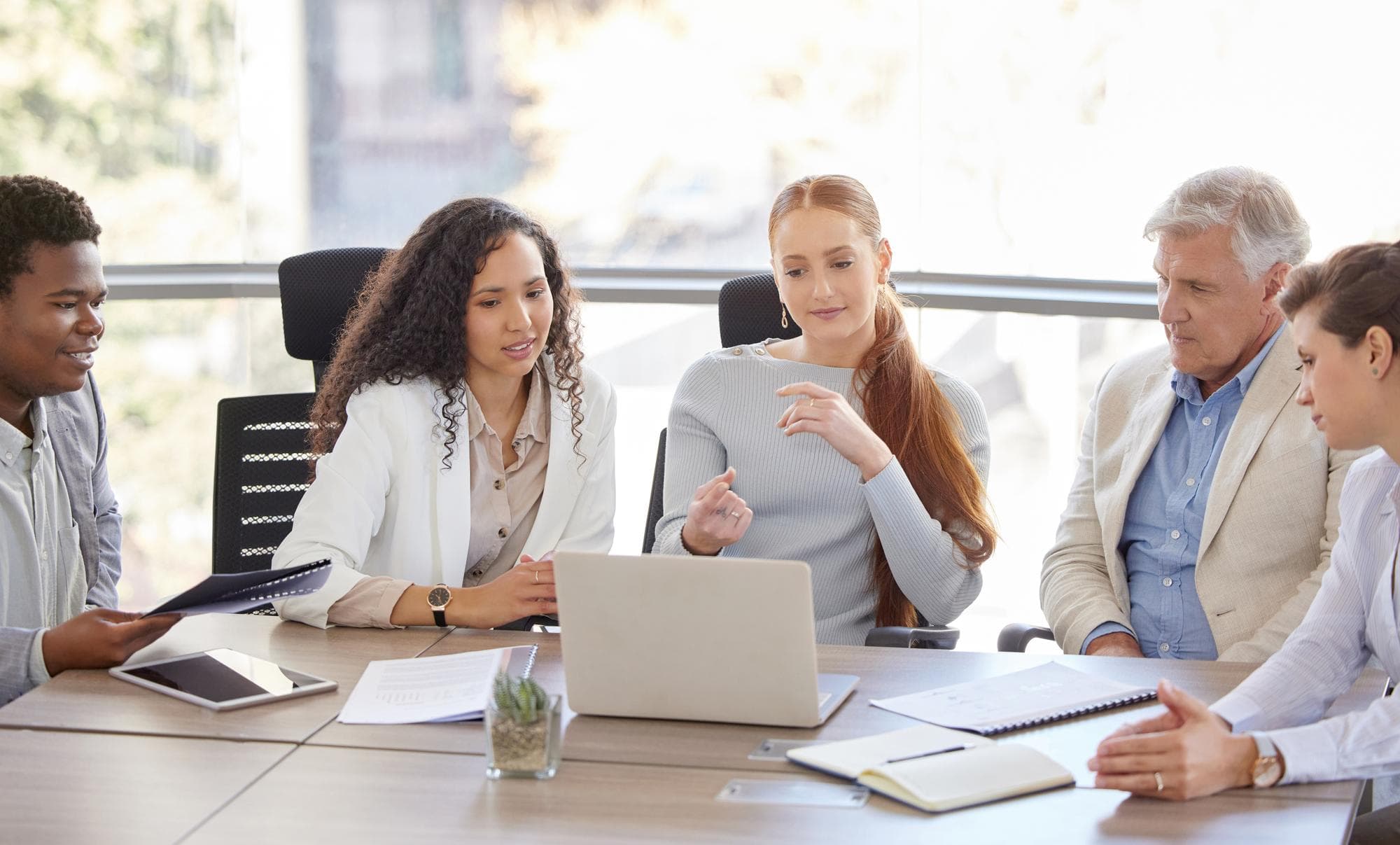 Committee members reviewing documents together in a meeting